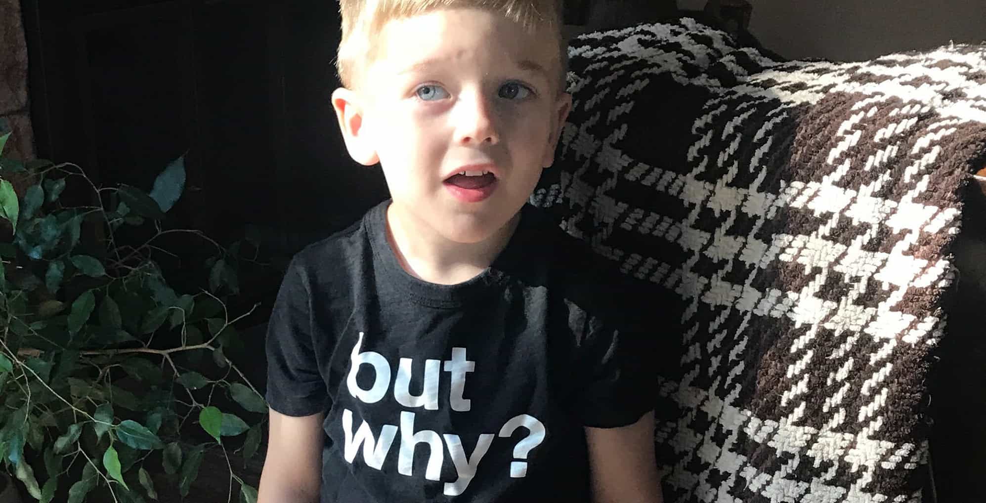 Child with "buy why" shirt
